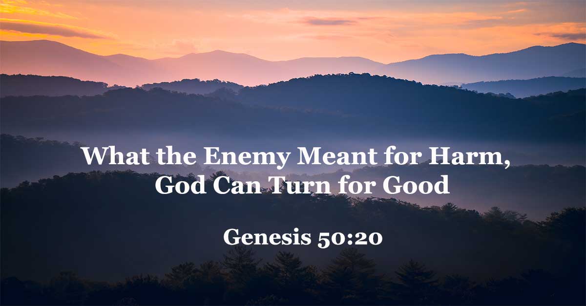 Misty mountain ridges with text “What the Enemy Meant for Harm, God Can Turn for Good – Genesis 50:20,” expressing God’s power to redeem suffering.